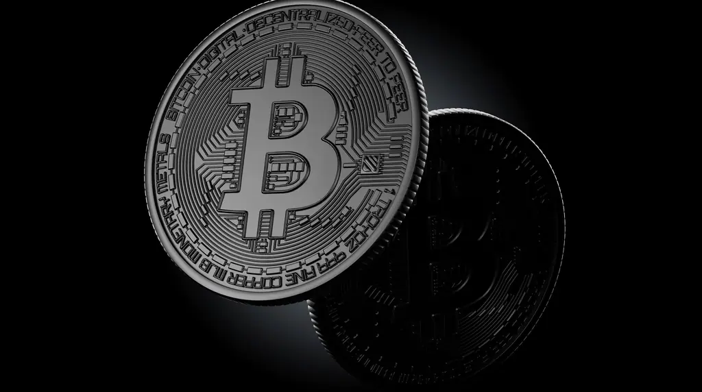 Two silver Bitcoin-themed coins against a black background.