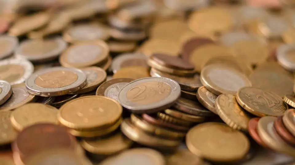 A heap of mixed euro and cent coins, softly out of focus at the edges.